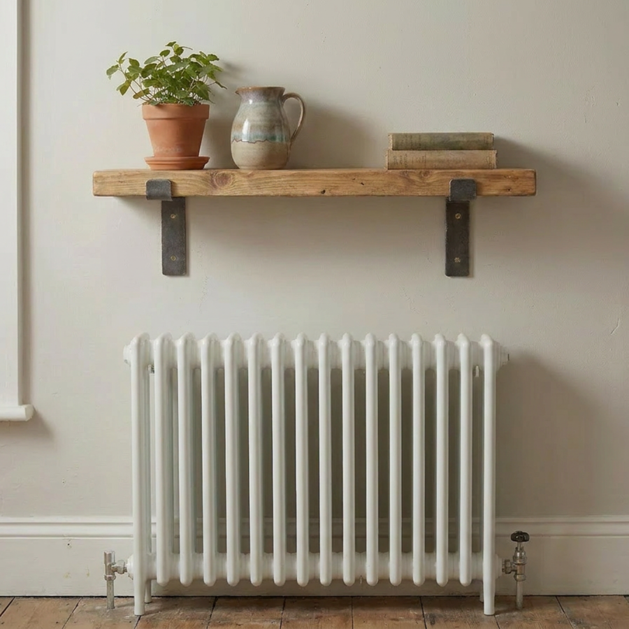 Rustic solid wood radiator shelf on industrial metal brackets above a radiator
