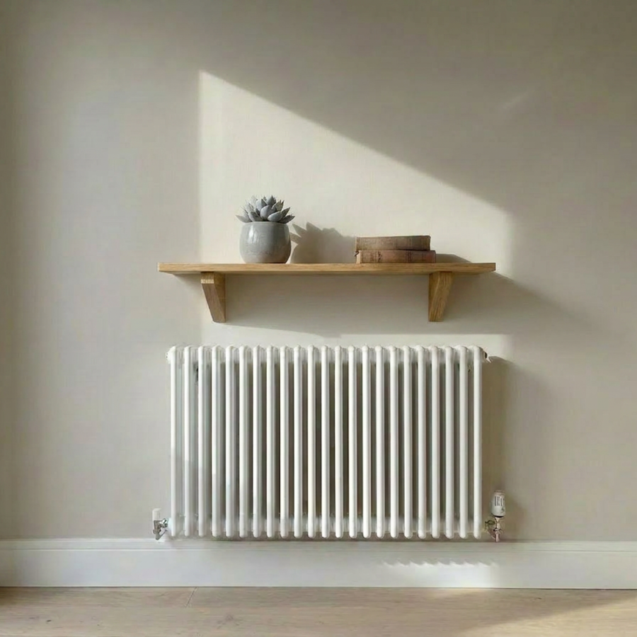 Solid oak radiator shelf on wooden brackets, mounted above a radiator