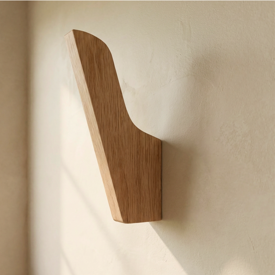 Wooden Oak wall hook on a beige wall