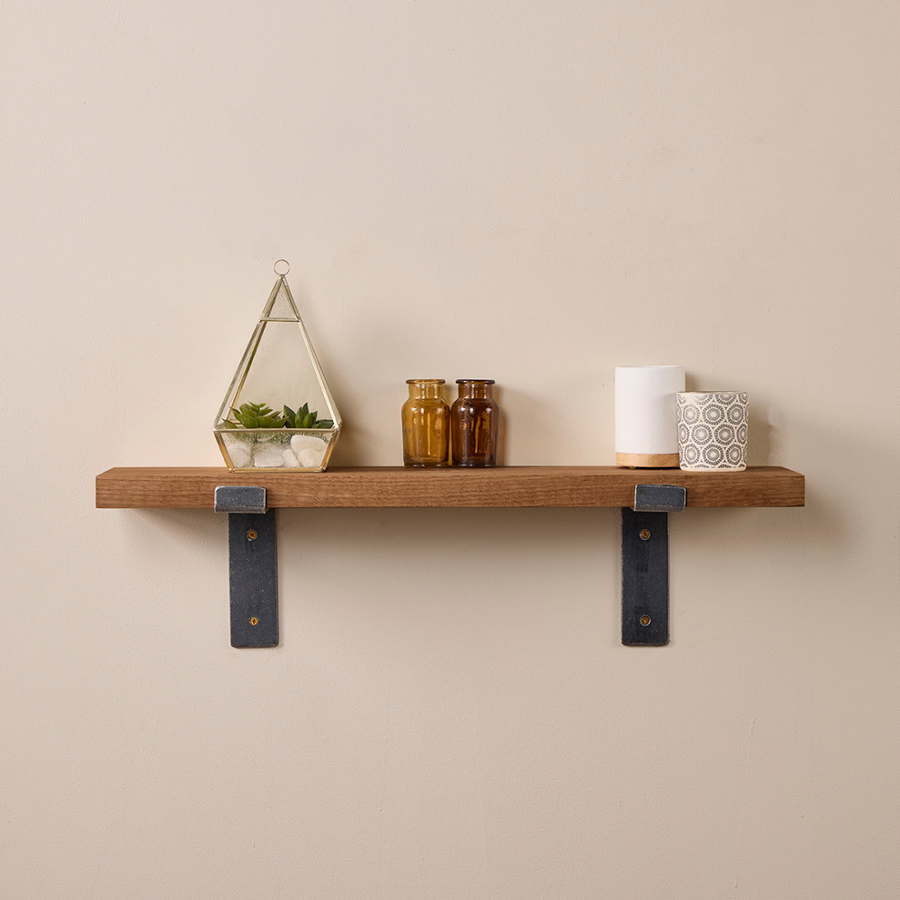 Walnut-stained solid oak shelf with metal lipped brackets, styled with candles and accessories