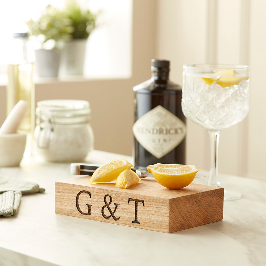 gin and tonic chopping board with a lemon being cut on top