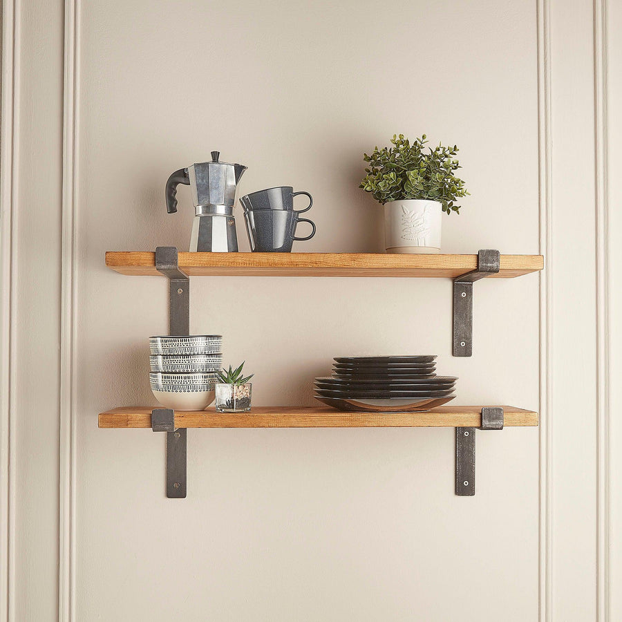 Scaffold board shelves with metal brackets styled in a kitchen with plates and coffee pot