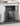 Powder-coated steel fire screen protecting hearth