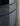 Close-up of a curved metal frame with mesh design against a neutral background