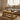 Wooden coffee table with decor items in a living room setting in medium wax finish