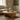 light wood round coffee table in a living room with a vase and books on top