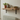 Rustic radiator shelf above a radiator, styled with a plant, jug and books