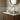 White Corian worktop on the dark wood wall hung vanity unit, ready for a sit on basin