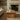 Farmhouse wooden coffee table with chunky plank top and rustic solid wood in a light living room