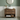 Freestanding wooden vanity unit with two drawers and an open shelf in a bathroom in a dark wax finish