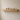 Slim oak floating shelf styled with a plant, books and a framed print in a living room
