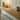Close up of the narrow oak radiator shelf showing the grain and 5cm thick edge