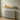 Slim oak radiator shelf above a radiator, styled with a plant and a framed print