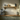 Narrow solid oak wall shelf, 10cm deep, on two curved wooden brackets, mounted on a wall