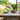 oak dining table and bench set in modern kitchen with garden view