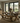 side view of solid oak dining table with x frame legs and matching bench