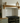 Close-up of a shaped oak corbel supporting the mantel shelf, showing the grain