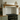 Close-up of a shaped oak corbel supporting the mantel shelf, showing the grain