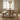 solid oak pedestal dining table with smooth top and central base styled with dining chairs in kitchen setting