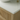 oak vanity unit with fluted draw fronts with white countertop and wooden cabinets