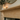 Close-up of shouldered rebate detail at top of solid pine fire surround upright, natural grain and knots visible