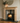 Solid pine fireplace surround shown from three-quarter angle, 225mm mantel shelf with 45mm overhang, shouldered upright detail