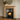 Solid pine fireplace surround shown from three-quarter angle, 225mm mantel shelf with 45mm overhang, shouldered upright detail