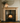 Pine fire surround with deep mantel shelf installed above wood burning stove, natural pine finish, handmade in Yorkshire