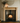 Victorian pine fire surround with corbel uprights installed above black wood burning stove, natural finish, slate hearth