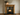 Victorian pine fire surround in medium wax finish, rustic pine grain and knots, corbel uprights above wood burning stove