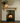 Pine corbel mantel shelf mounted above a fireplace, a solid timber shelf on two decorative corbels