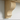 Close-up of a shaped pine corbel supporting the mantel shelf, showing the bracket profile and grain