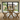 side view of solid pine dining table and bench set with x frame legs with benches in a room with large glass doors leading to a garden.