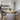 round wooden dining table with hairpin legs in kitchen setting