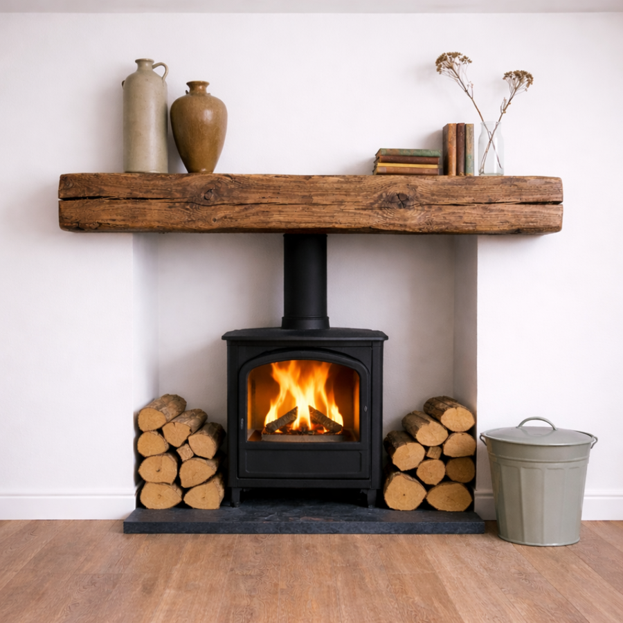 a rustic oak aged fireplace mantel above a log fire