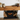 Rustic oak beam detail showing softly rounded worn edges and aged texture