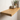 Solid oak floating shelf with a rustic grain shown on a plain wall, side profile visible