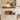 Rustic oak floating shelf showing natural knots and grain in a bright kitchen
