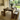 Rustic pine farmhouse dining table and bench set with straight legs in a bright kitchen with natural light and garden view