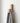 small wooden coat hook mounted on wall with hanging cloth