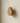 Single solid oak oval wooden wall hook mounted on neutral plaster wall