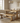 solid oak pedestal dining table with matching benches in modern dining room showing clean surface and open base design
