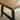 Close up of solid oak dining table top showing natural grain detail, knots and oiled finish in a warm tone