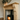 Solid pine fire surround showing corbel-detailed uprights and mantel shelf, natural wax finish, handmade in Yorkshire