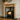 Victorian style pine fireplace surround with fire burning in wood burning stove, corbel frame profile