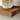 Side close-up of a walnut floating shelf showing the dark oak wood grain edge.