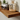 Close-up of a walnut floating shelf showing dark wood grain and decorative items.