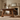 rustic wooden coffee table in a living room with a fireplace and shelves.