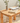 rustic wooden coffee table in a garden that has books and a plant on