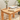 rustic wooden coffee table in a garden that has books and a plant on